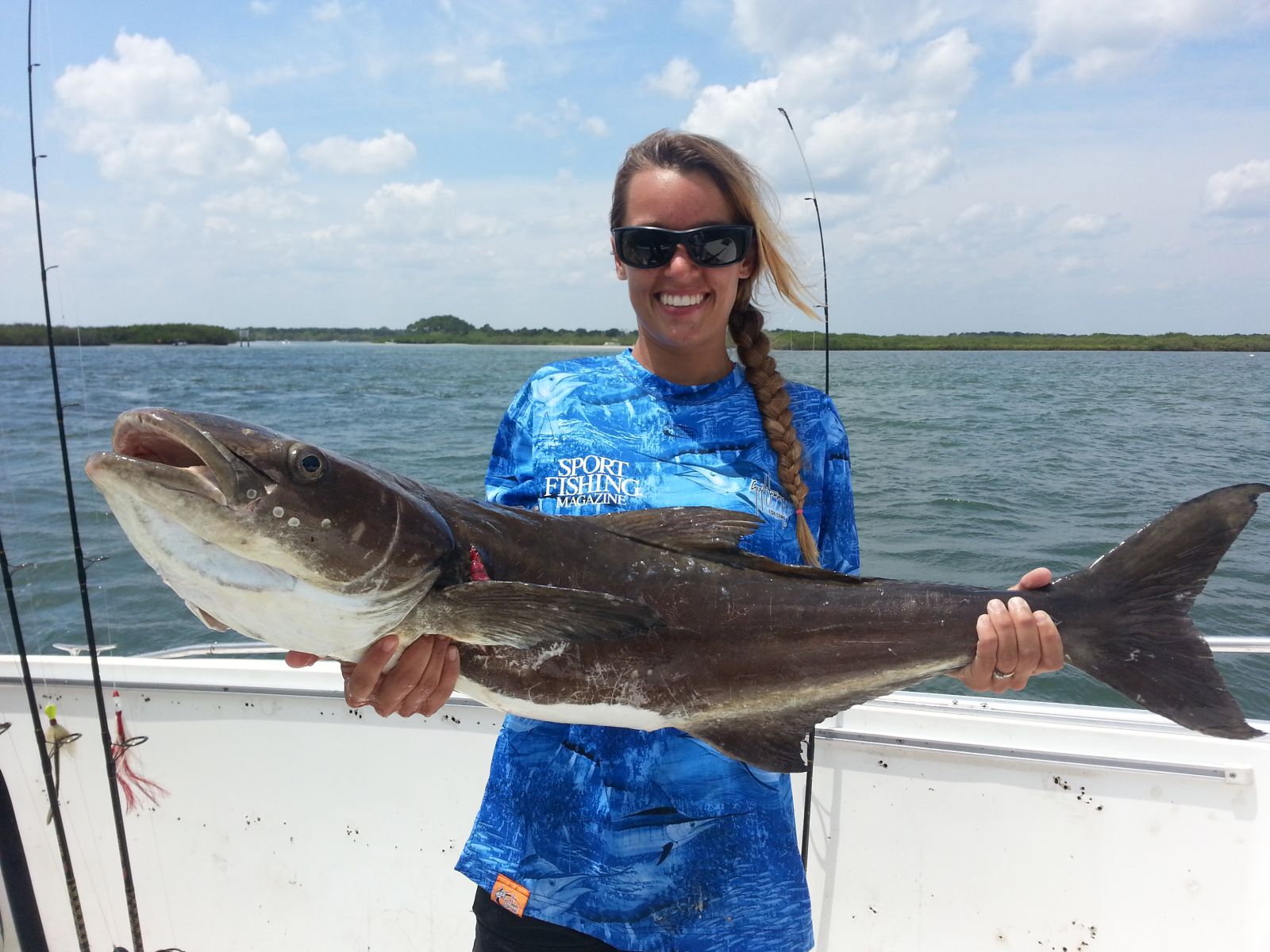 Woman holds caught Cobia