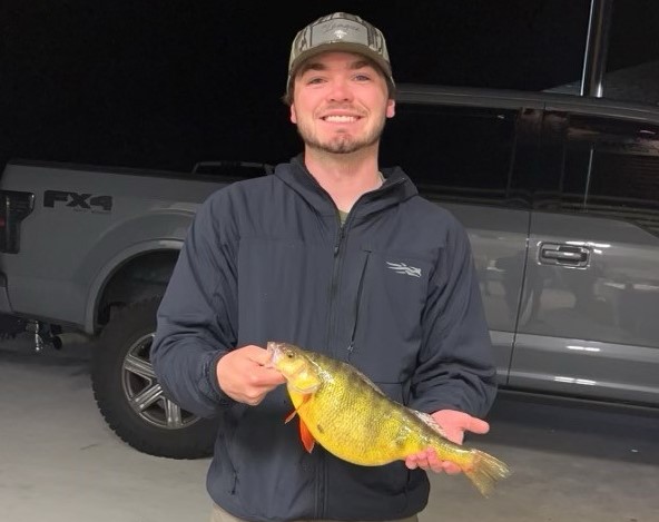 Emerson Mulhall holding his state record yellow perch