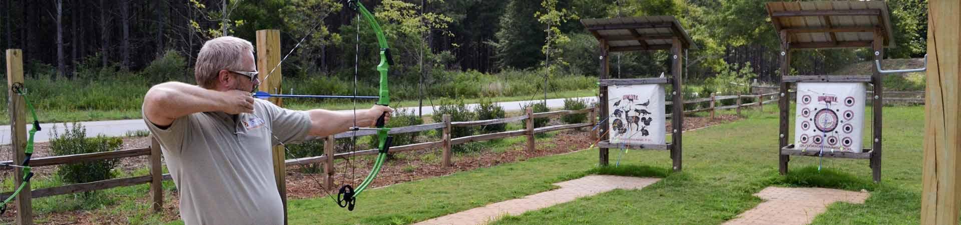 man practicing archery at range