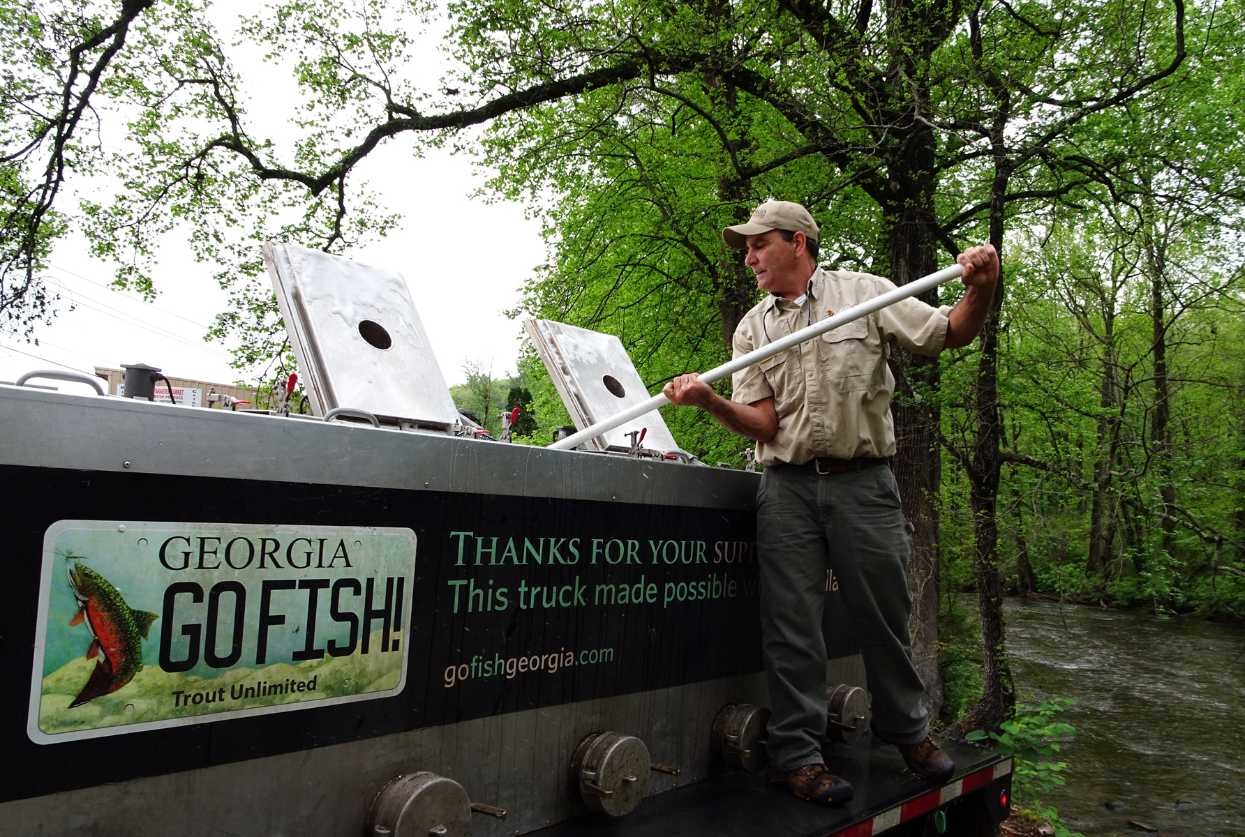 Man stocking the river with trout