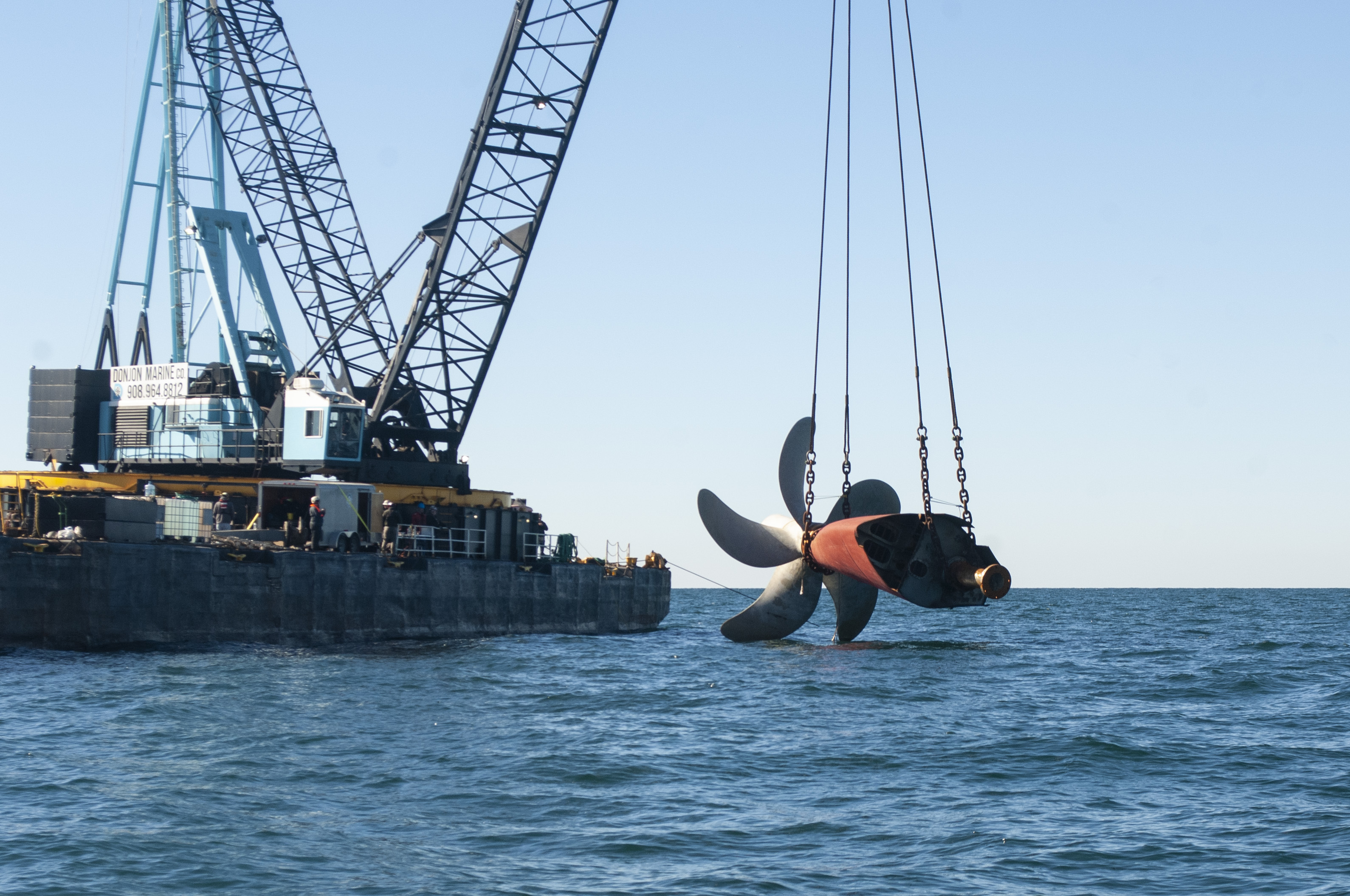 Golden Ray propeller being lowered into water by crane
