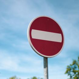A red caution road sign.