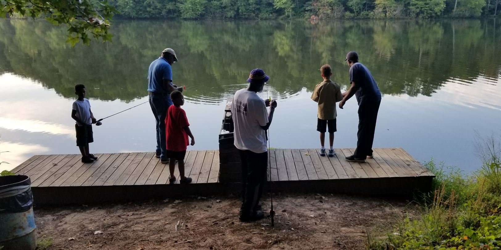 Three Children fish on a Dock