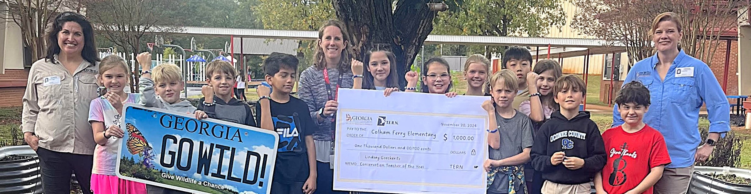 Group photo of kids holding a grant check