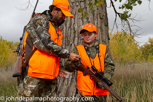 man giving boy hunting instruction